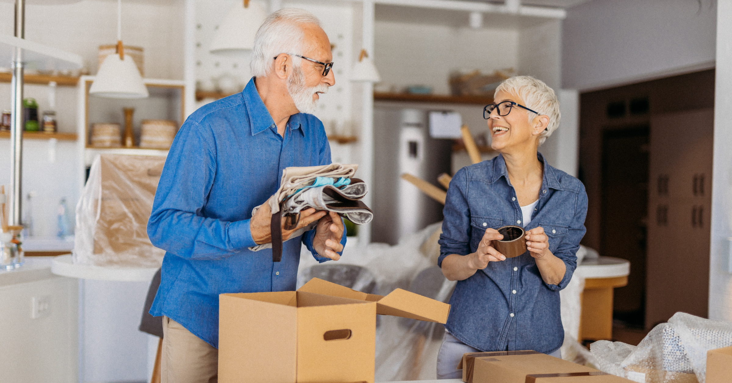 senior couple packing their belongings to move to a ccrc